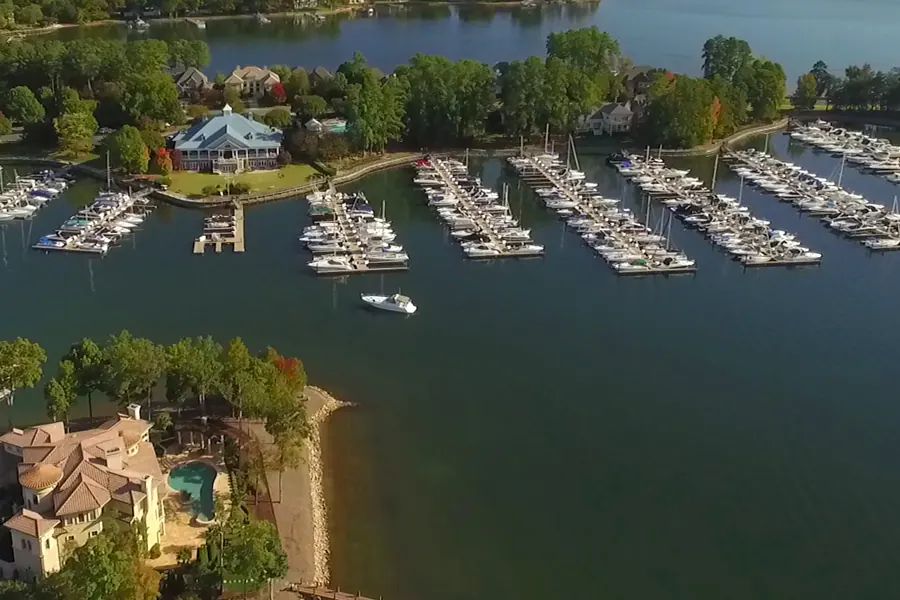 Aerial view of the Peninsula Yacht Club marina in Cornelius, with rows of sailboats and powerboats at the docks and Lake Norman stretching to the horizon